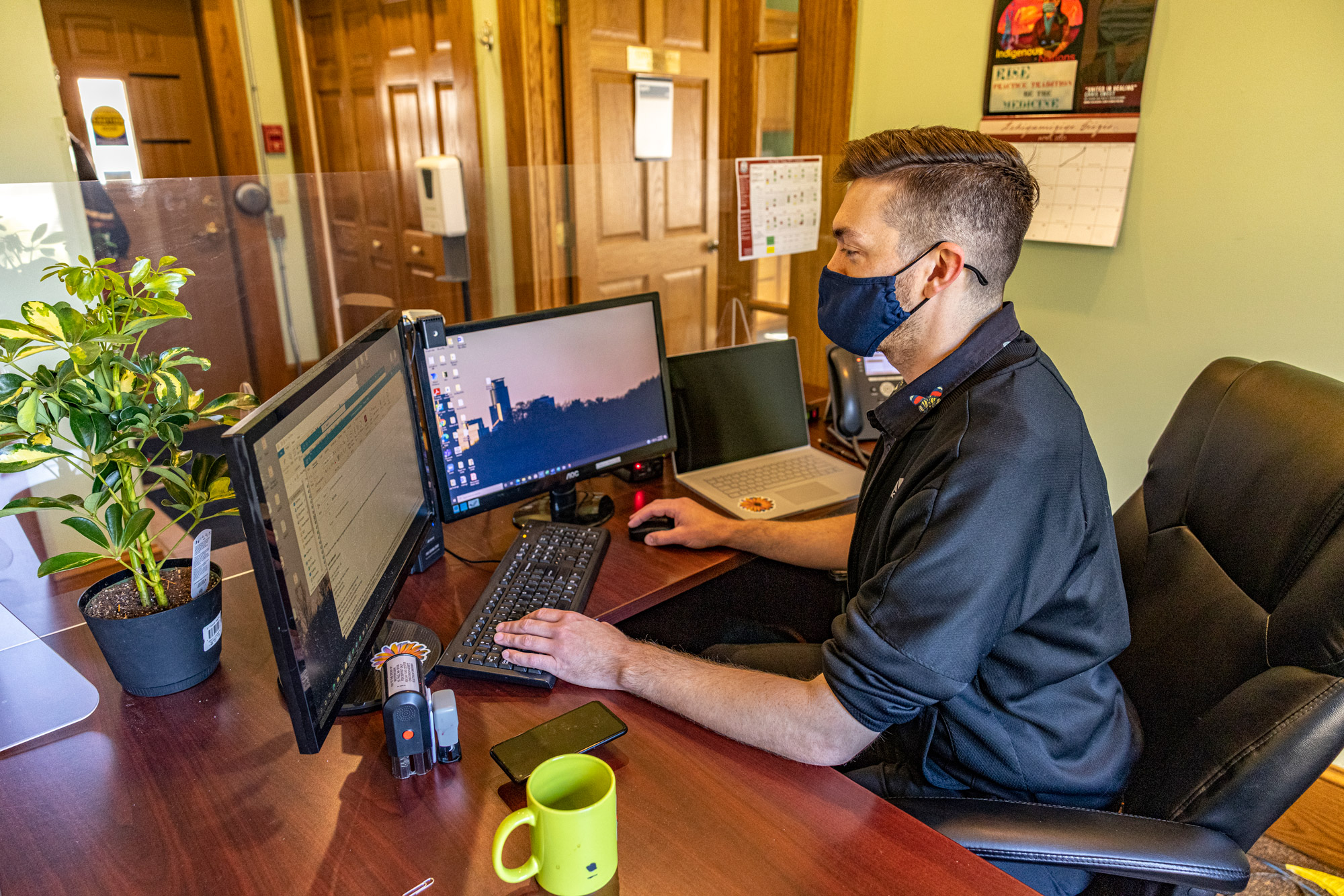 A staff person working at the computer