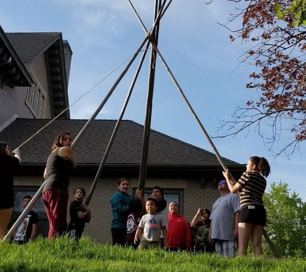 ADYC staff putting up a tepee